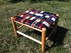 a small wooden stool sitting in the grass