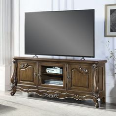 an entertainment center with a large flat screen tv on it's stand in a living room