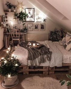 an attic bedroom is decorated with plants and lights