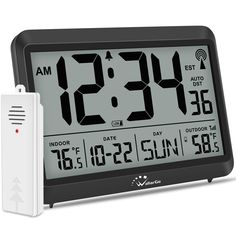 an alarm clock and thermometer are on display