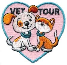 a dog and cat hugging each other in the shape of a heart with vet tour written on it