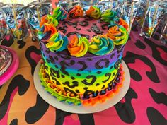 a multi - colored cake on a colorful table cloth