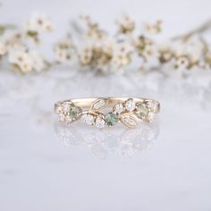 a close up of a ring with flowers in the background