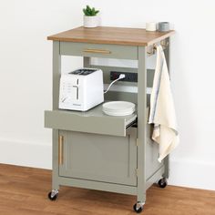 a small kitchen cart with a toaster on top