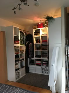 the closet is full of clothes and other things to wear in it's storage area