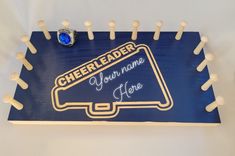 there is a sign that says cheerleader you name here with pins in the shape of a basketball hoop