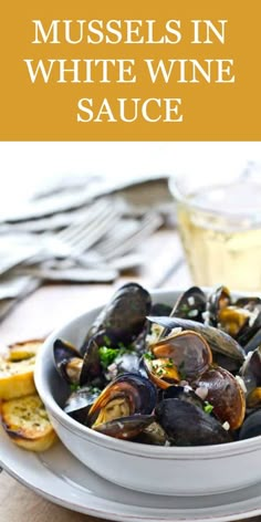 steamed mussels with garlic and herb butter in a white bowl on a plate