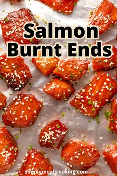 salmon burnt ends with sesame seeds and seasoning on top, sitting on parchment paper