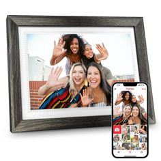 an image of two women with their hands in the air and one holding up her phone