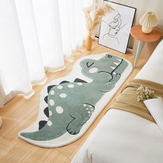 an elephant rug is on the floor next to a bed