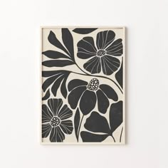 a black and white flower print on a wall next to two vases