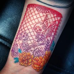 a colorful tattoo on the arm of a person with flowers and a skeleton holding an umbrella