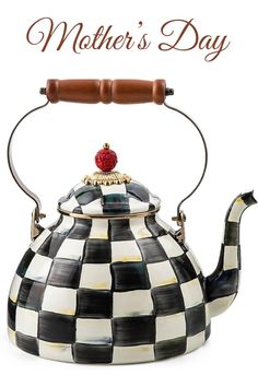 a black and white checkered tea kettle with a red rose on it's top