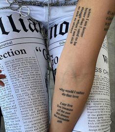 two people with tattoos on their arms are holding each other's hands and reading newspapers