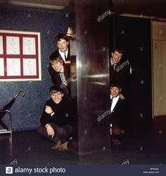 the beatles posing for a photo in an elevator