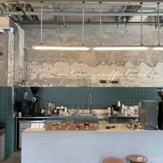 the interior of a coffee shop with green tiles