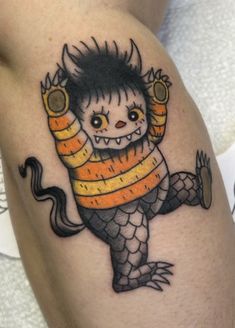 a small tattoo with an evil creature on it's arm