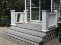 a porch with white railings and windows