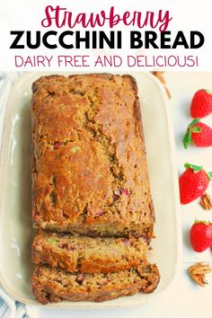 strawberry zucchini bread on a white platter with strawberries in the background