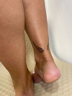 a close up of a person's foot with a tattoo on the side of her leg