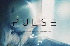 a person wearing a helmet and holding a cell phone in front of a window with the word pulse on it