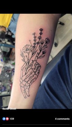 a person with a flower tattoo on their arm