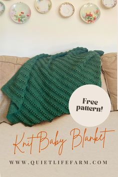 a green knitted baby blanket sitting on top of a couch next to plates and cups