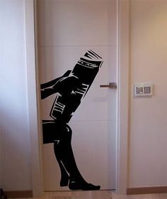 a door with a sticker of a woman carrying a bucket and holding a book