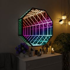 a mirror that is sitting on top of a dresser next to a potted plant