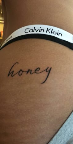 the back of a woman's stomach with her name written on it