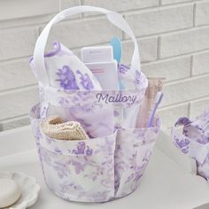 a purple and white bag filled with personal care items sitting on top of a counter