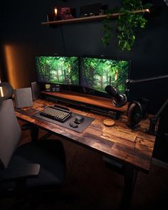 two computer monitors sitting on top of a wooden desk