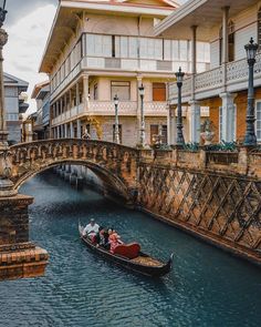 two people in a small boat on a canal