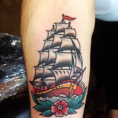 a tattoo on the leg of a person with a ship