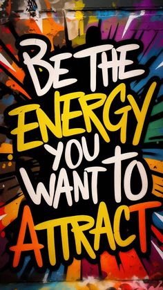 the words be the energy you want to attract are painted in bright colors on a black background