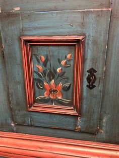 an old wooden frame with flowers painted on it