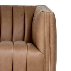 a brown leather chair with pleated arms and footrests on an isolated white background