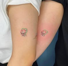 two people with small tattoos on their arms