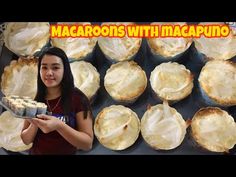 a woman holding a tray filled with baked goods next to other pies and muffins