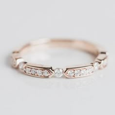 a rose gold wedding band with three diamonds