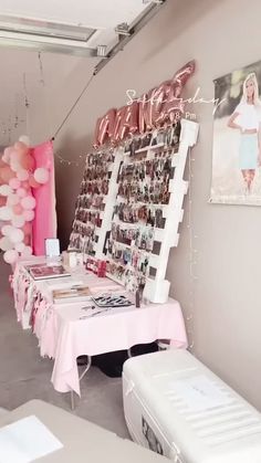 a table with balloons and pictures on it in a room that is decorated for a woman's birthday