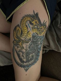 a woman with a dragon tattoo on her thigh