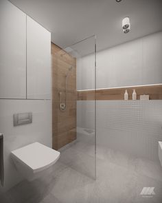 a bathroom with a toilet, sink and shower stall in the middle of it's walls