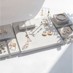 an assortment of jewelry displayed on concrete blocks