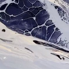 an aerial view of snow covered mountains and valleys