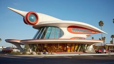 an unusual building sits in the middle of a parking lot