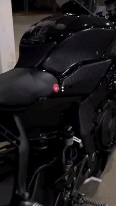 a black motorcycle parked in a garage