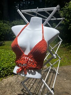 ☀️ Embrace the warmth of summer with our Handmade Orange Crochet Crop Top - a radiant creation that exudes vibrancy and handmade charm. Meticulously crafted, this crop top features a halter tie and a unique mesh-like accent, making it a standout addition to your wardrobe. 🧶 Handmade with love and attention to detail, each stitch in this orange crochet crop top reflects the artistry and dedication that goes into creating a one-of-a-kind piece. The sun-kissed orange hue adds a pop of energy, maki Handmade Triangle Halter Top For Spring, Handmade Bohemian Crochet Top For The Beach, Bohemian Hand Knitted Crochet Top For Vacation, Handmade Halter Top For Spring Vacation, Handmade Halter Top For Vacation In Spring, Handmade Crochet Top For Summer Festivals, Handmade Yarn Crochet Top For Summer, Handmade Fitted Crochet Top In Cotton Yarn, Handmade Triangle Halter Top For Beach