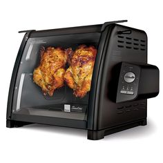 two chickens are cooking in the toaster oven