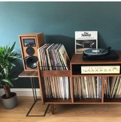 a record player sitting on top of a wooden shelf